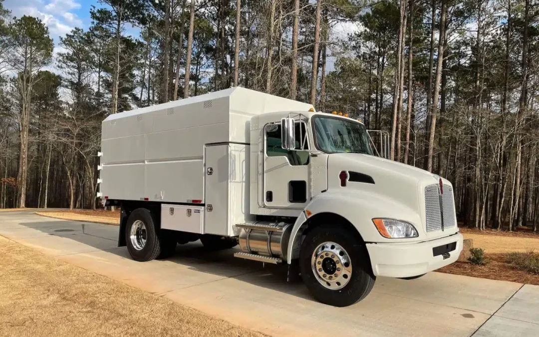 Why do chipper bodies make wood debris hauling safer and more efficient?