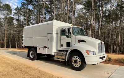 Why do chipper bodies make wood debris hauling safer and more efficient?